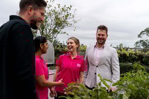 E4 Josh, Ed and two nurses discussing by a flower bed or vegetable garden smiling 4
