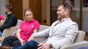 E4 nurse in pink uniform talking to Josh Hill on chairs 2