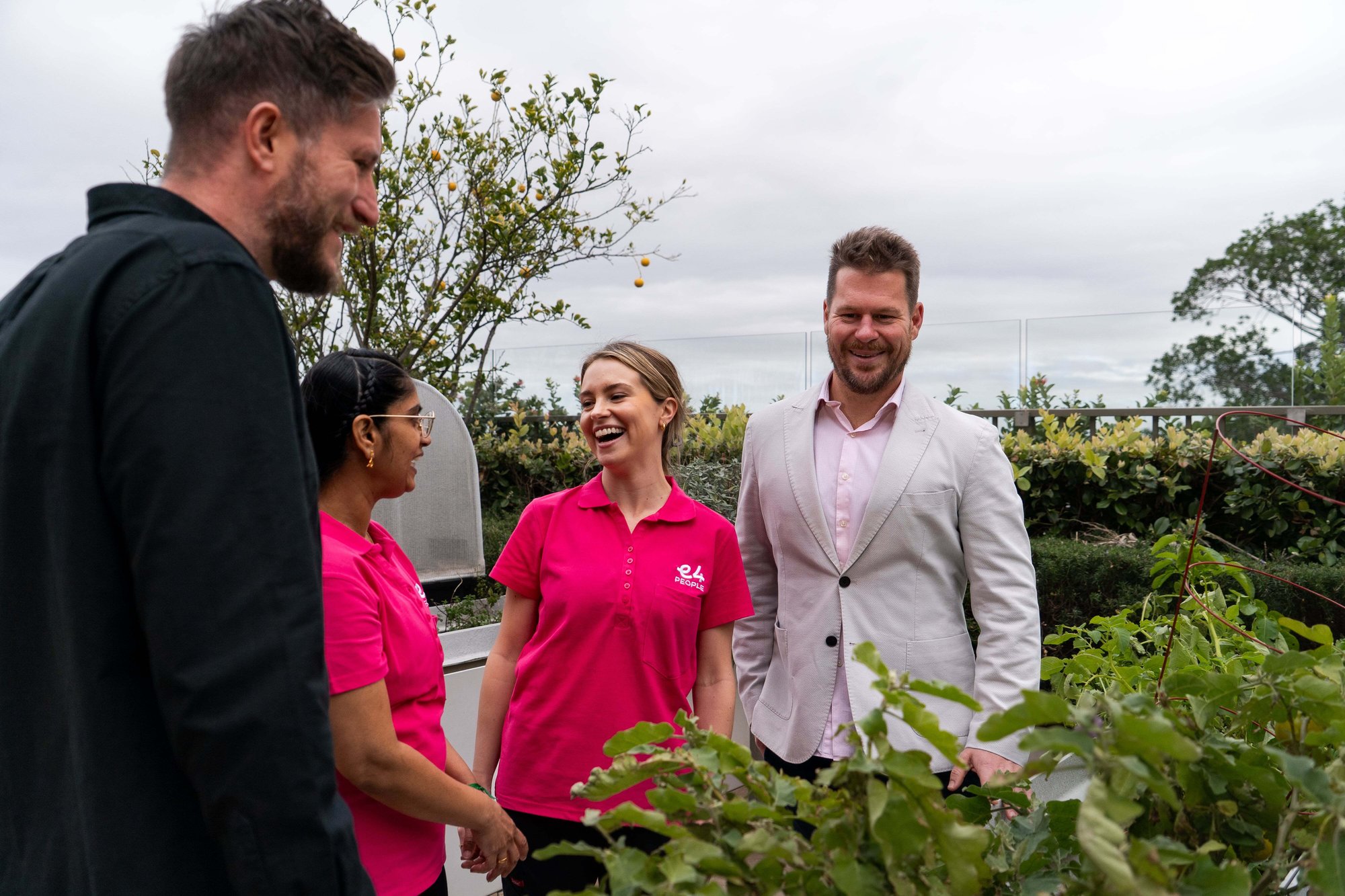 Josh, Ed and two nurses discussing by a flower bed or vegetable garden smiling 3 Josh, Ed and two nurses discussing by a flower bed or vegetable garden smiling 3